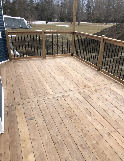 finished custom walkout deck with Sienna pressure treated boards
